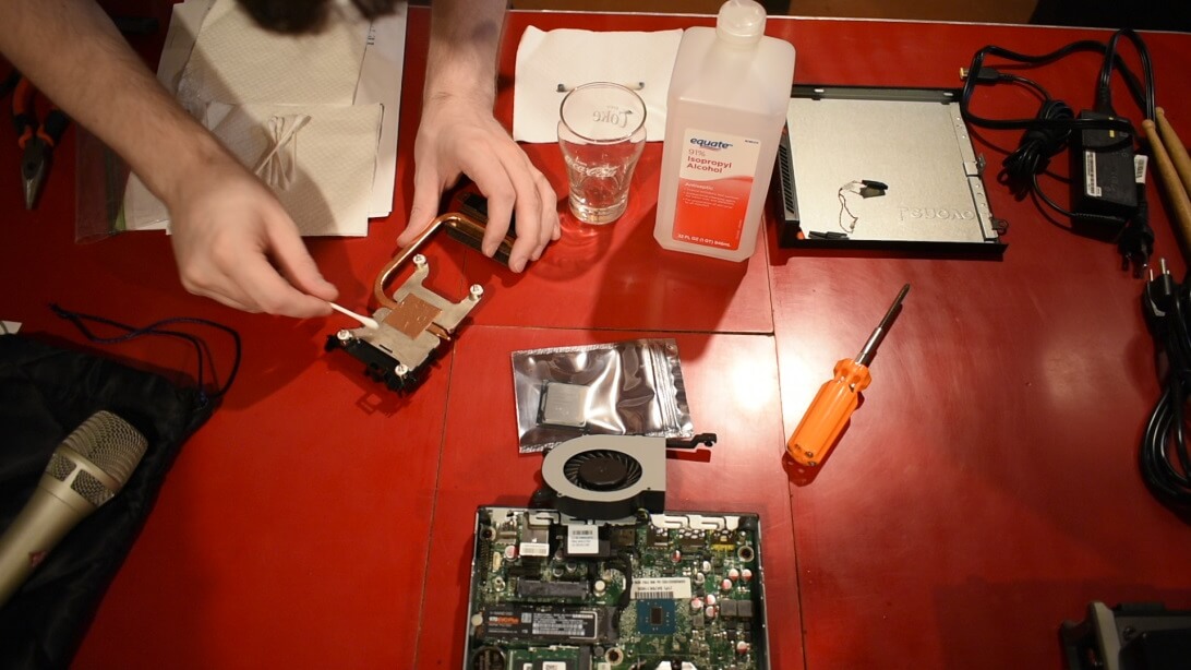 Applying new thermal compound to a Lenovo M900 Tiny Desktop computer.